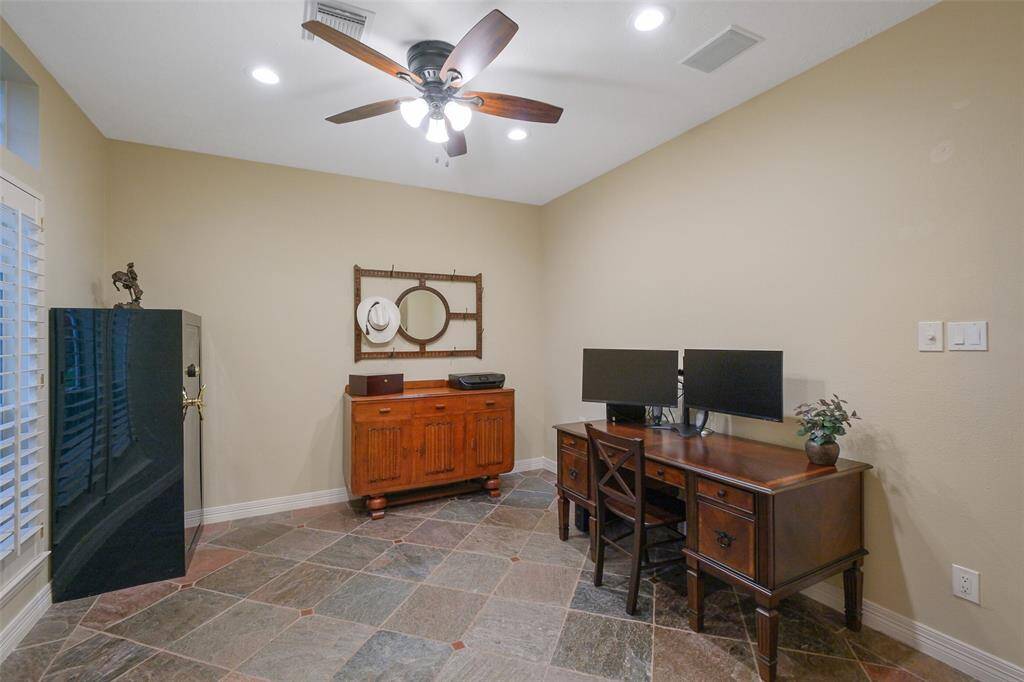 This front room is perfect as a home office or formal living space, featuring slate flooring, recessed lighting, a ceiling fan, built-in speakers and stylish plantation shutters. Also plumbed for a future bar.