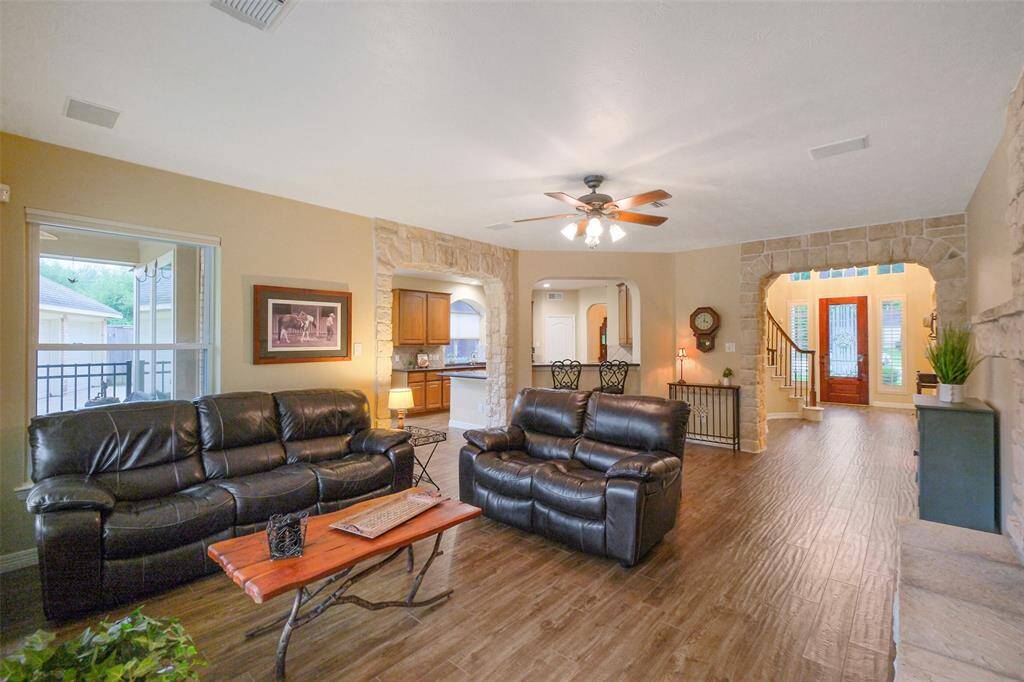 Beautiful wood-look tile and striking stone accents enhance the home's charm.