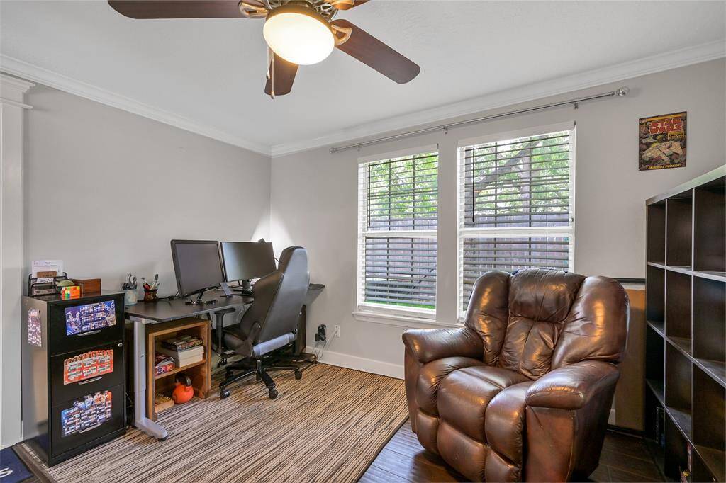 Front bedroom features hardwoods, ceiling fan and crown molding.