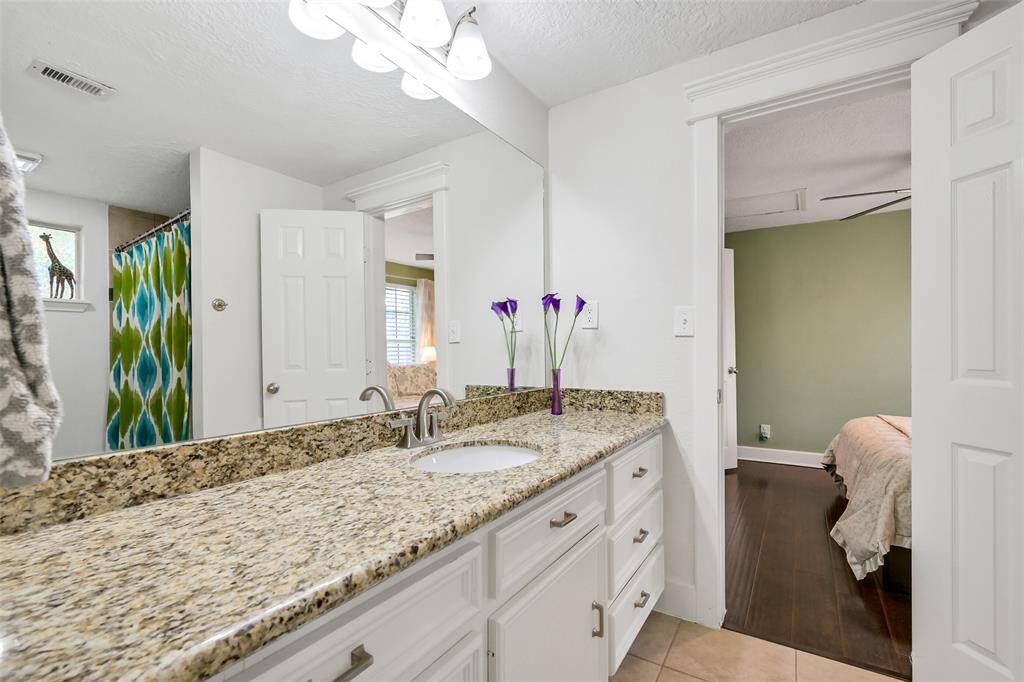 Jack & Jill bathroom located between front and middle bedroom. Bathroom includes great storage, granite counter and shower/tub combo.