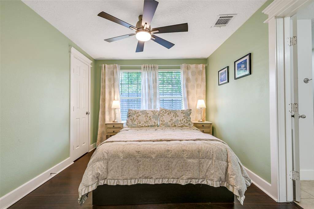 Secondary bedroom boasts of natural light, designer paint, 2 inch wood blinds and ceiling fan.