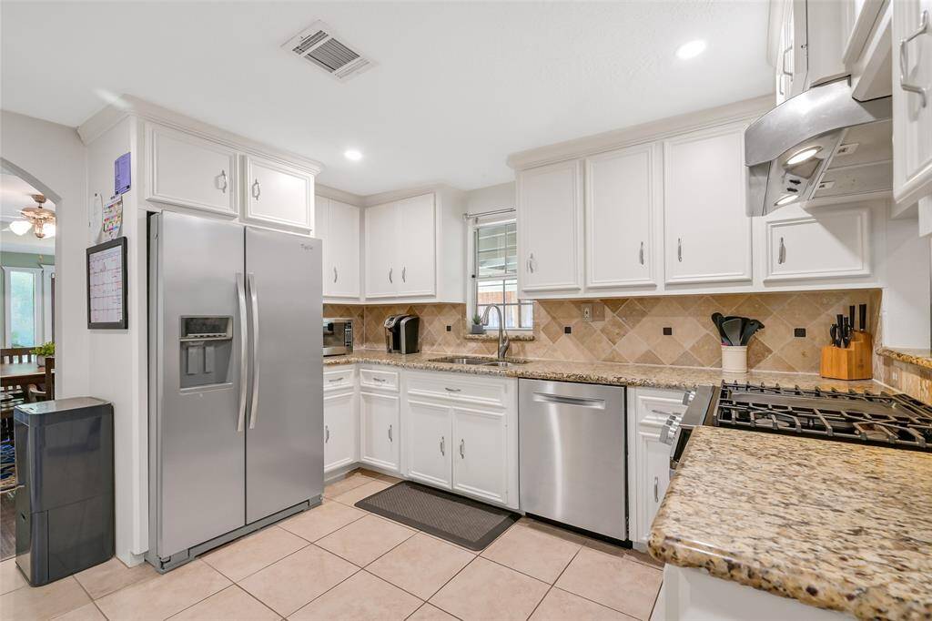 The updated kitchen boasts of granite countertops, stainless appliances, Bosch dishwasher 2022 and gas range 2024.
