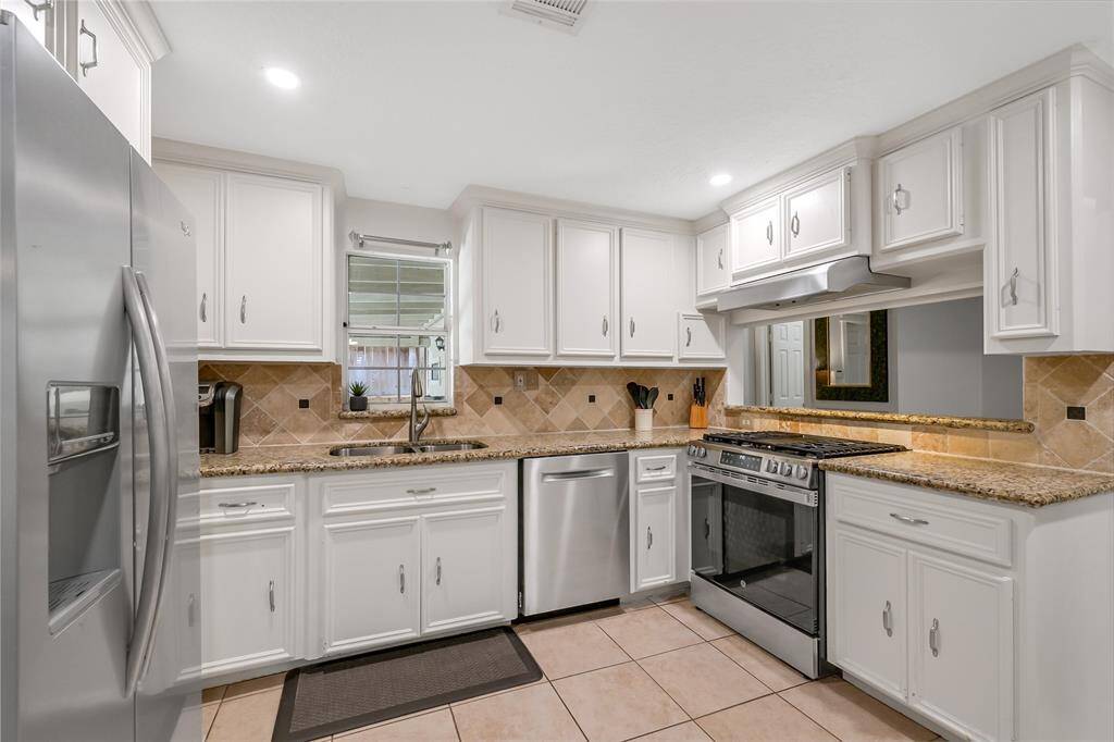 Kitchen includes gracious cabinets, recent LED recessed lights and great counter space.