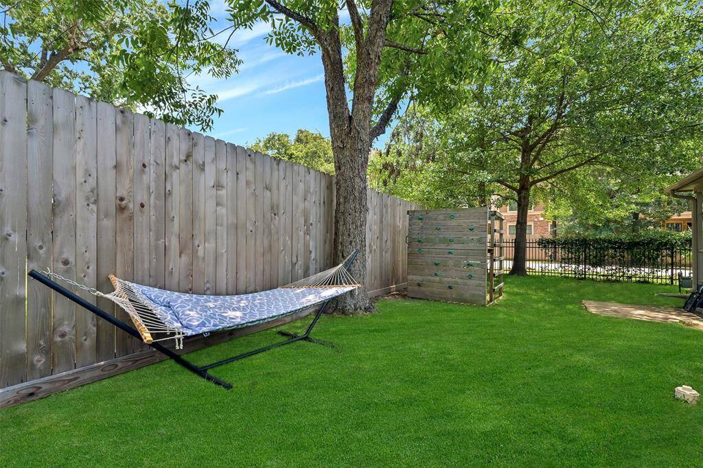 Large side yard includes beautiful trees and  fence 2022.