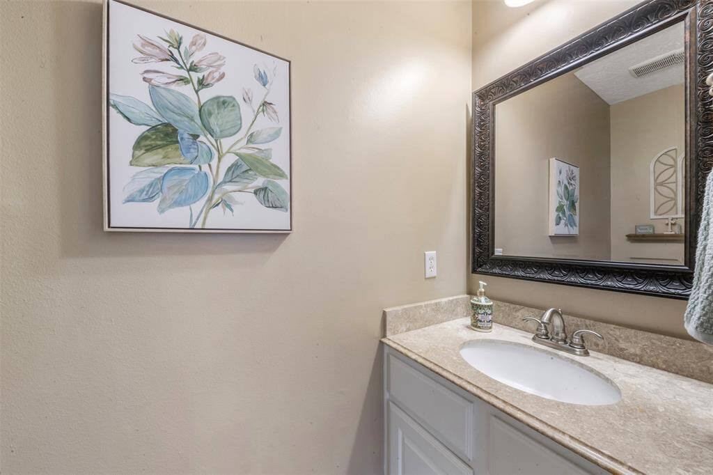 Half bath with updated countertops and cabinets.