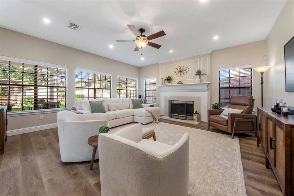 The living room features recessed lighting and a gas log fireplace.