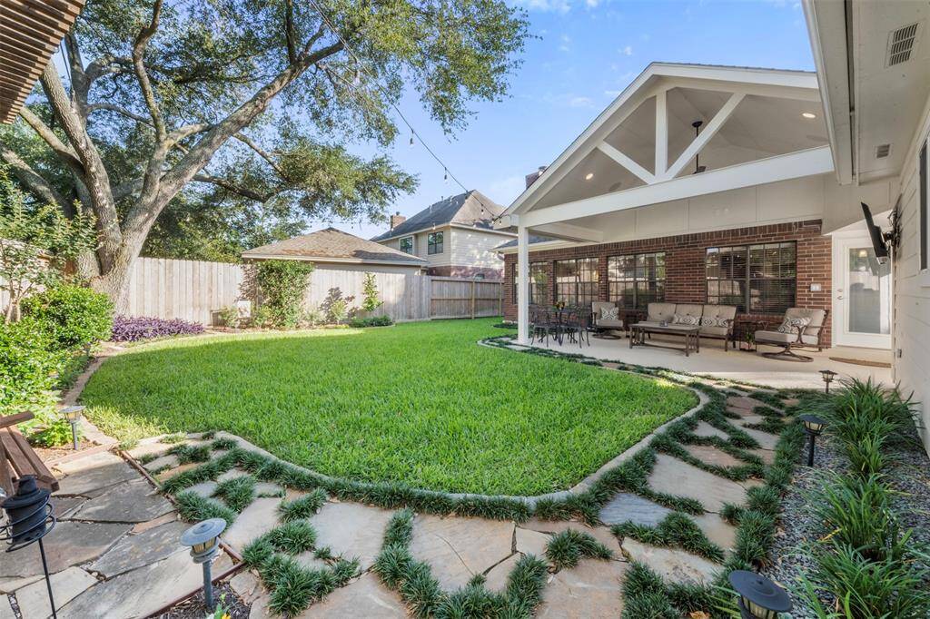 Beautifully landscaped with sprinkler systems in the front and back, outdoor swing, and the covered porch was installed in 2021.