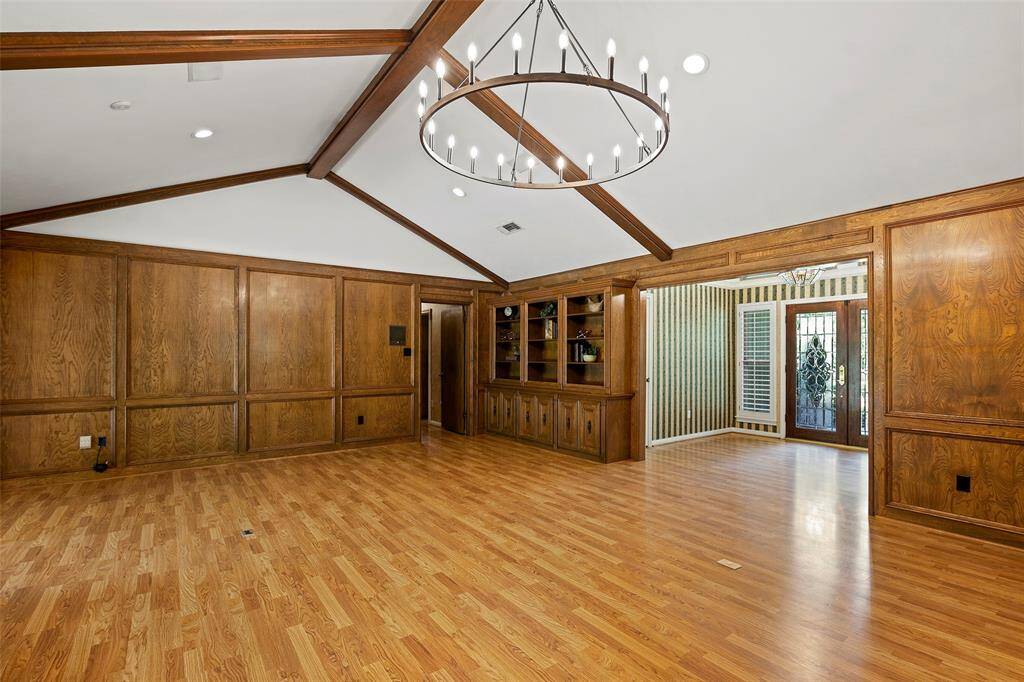 This chandelier accents this grand space just perfectly, creating the perfect ambiance! And the added feature of the warm laminate floors that flow throughout offers a timeless look that is so easy to maintain! Custom built-ins for display of treasured items, entertainment equipment or maybe special beverages is such a great added feature!