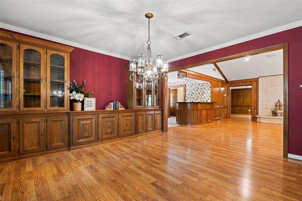 This wall of expansive built-ins is ideal for storing party supplies, serving pieces or that special china that has been passed down through the generations! We love the open space for serving up dinner buffet style!