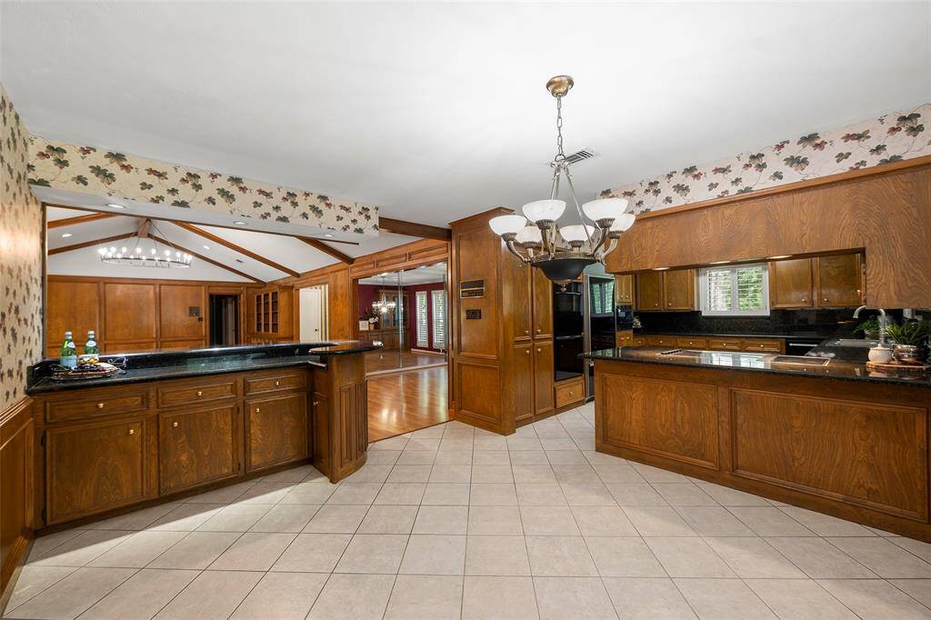 This view from the breakfast room shows the raised bar area, and a glimpse at the gorgeous kitchen!