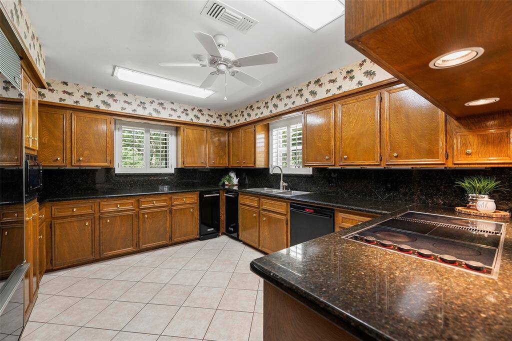 This kitchen boasts granite countertops, ready to roll out those tasty meals, a BOSCH dishwasher, Kitchen Aid ice-maker for serving up cold drinks and a convenient Kitchen Aid trash compactor!