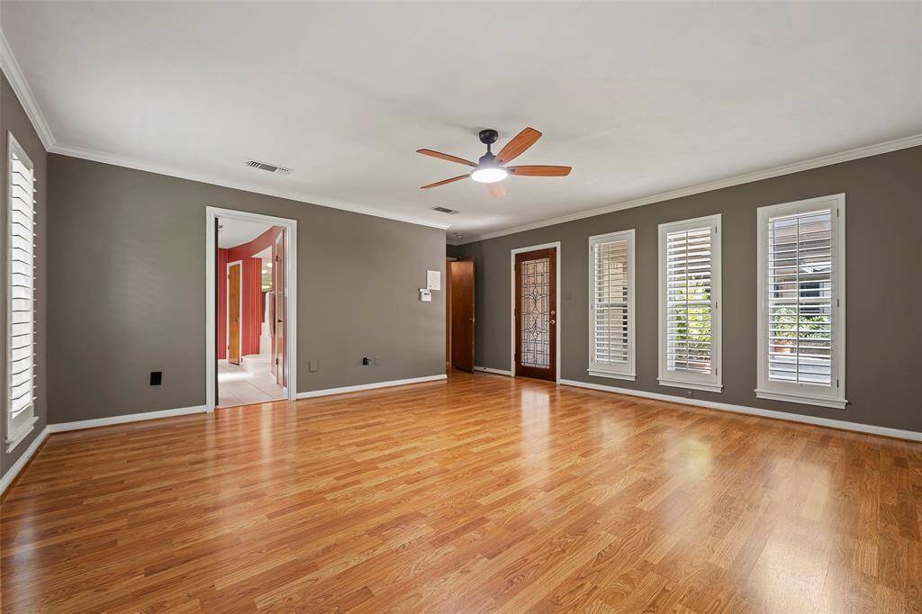 Your serene primary suite awaits you for peaceful slumber! A gorgeous paint tone with crown molding and Plantation shutters makes this room oh so dreamy!  A leaded glass door leads to the outdoor patio area for those late nights of star gazing and listening to the nature chirp at night!