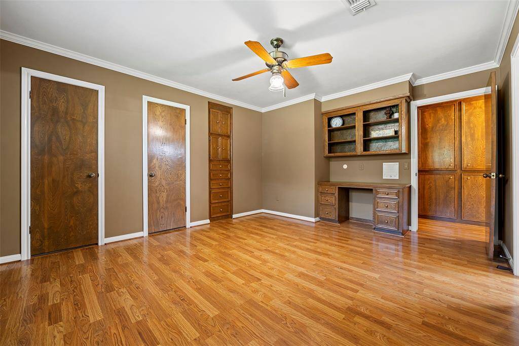 This home features 3 secondary bedrooms!  The custom built-in desk is ideal for homework or a place to sit and surf the web! Take a peep at the built-in wardrobe and the storage cabinets in the hallway!