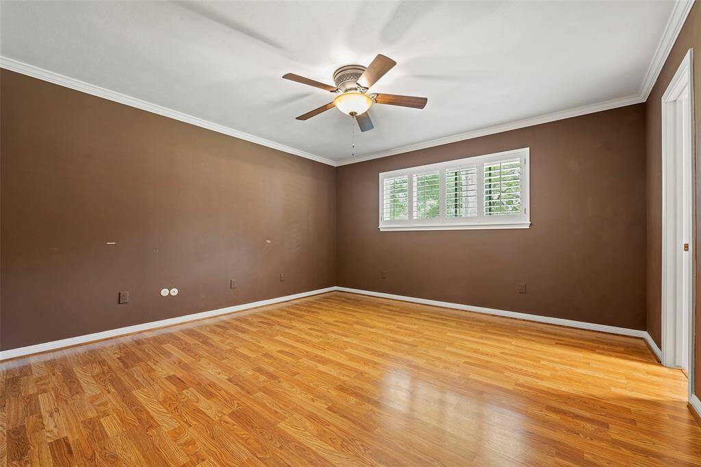 Another secondary bedroom that is just as spacious as the next!  Crown molding, plantation shutters and gorgeous laminate flooring!