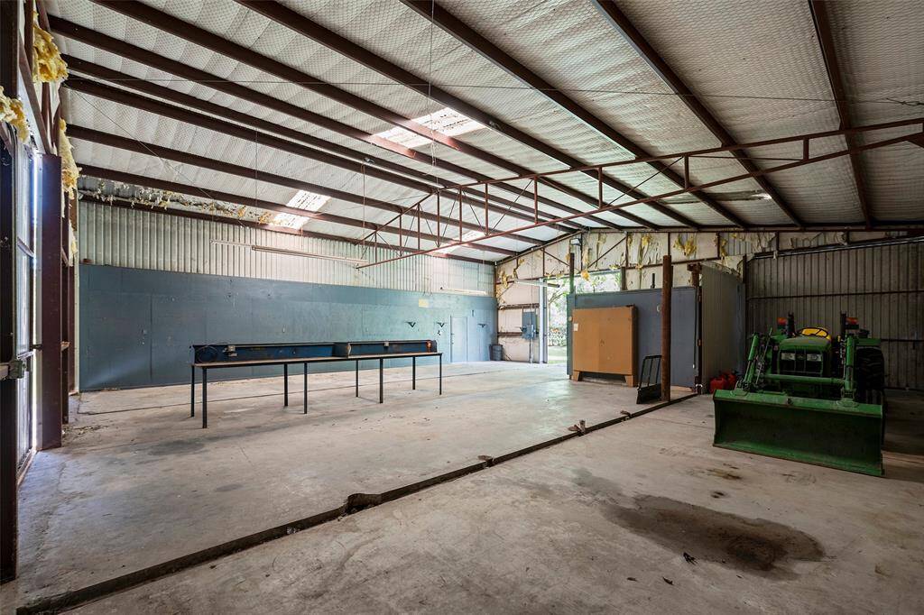 We open the door to see more!  This would make a great place for a car collection, a MAN cave or to keep your equipment that maintains the property!