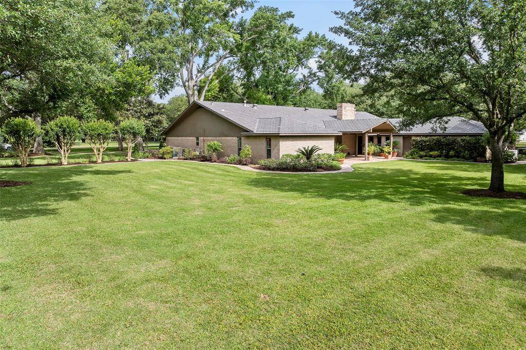 As we get closer to the home, you can just feel the pride in ownership! A well-maintained lawn that has about 1-acre of sprinkler system access looks just as lush and beautiful as the trees that surround it!