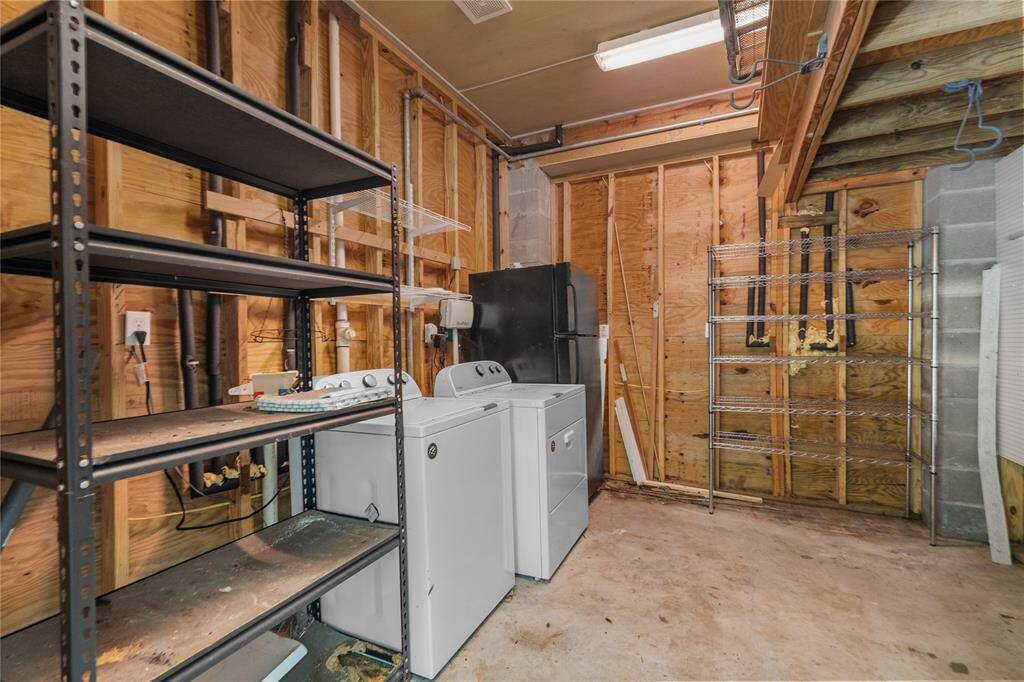 washer room with plenty of other storage.
