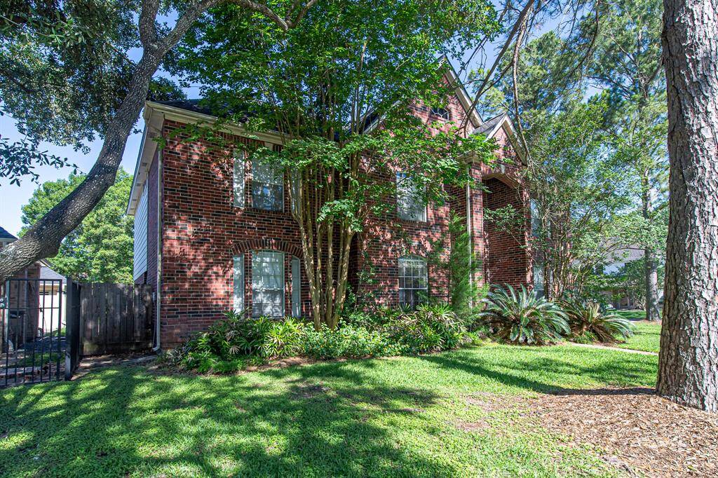 Stunning curb appeal surrounded by numerous shade trees