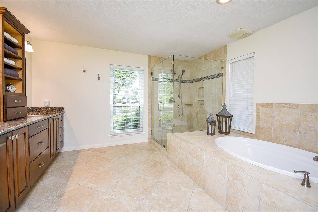 Luxurious & updated Primary Bath with Oak Cabinets & Soaking Tub