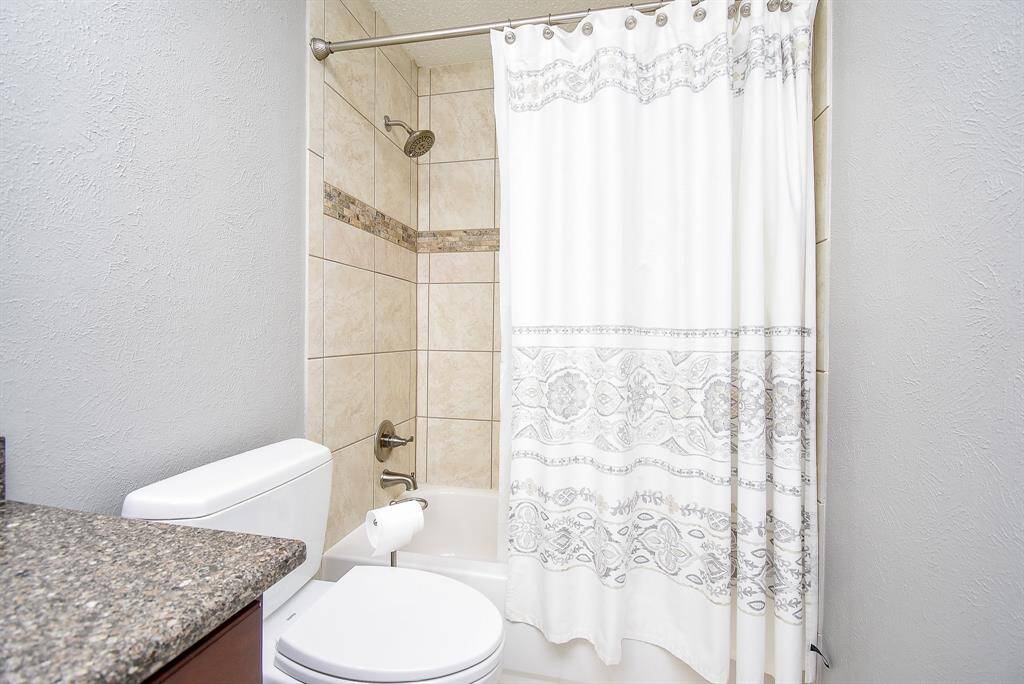 Secondary bathroom is updated with granite & a shower/tub combo