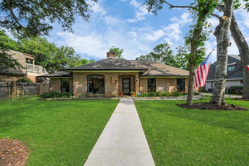 Elegant one-story nestled on a quiet cul-de-sac, surrounded by mature trees and lush landscaping. Picturesque updated windows add timeless character and a warm, welcoming presence.