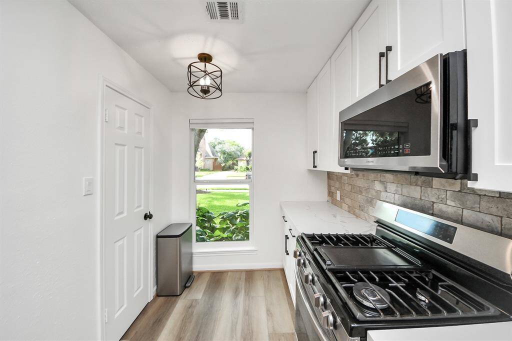 A gas range makes this kitchen a dream for those who love to cook, while a thoughtfully placed window lets natural light brighten the space.