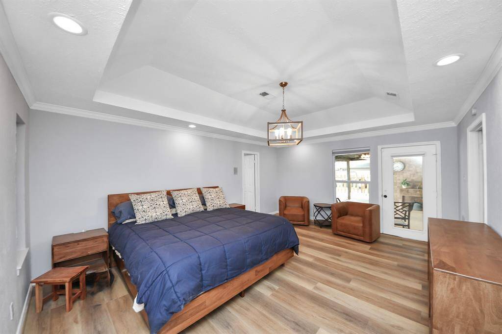 The primary bedroom is a true owner’s retreat, offering ample space for bedroom furniture as well as a cozy sitting area—perfect for relaxing in privacy and comfort.