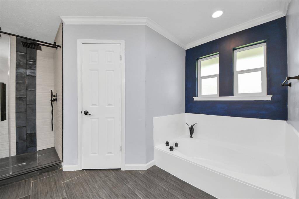 Bathroom windows invite natural light while thoughtfully positioned to maintain privacy, balancing brightness and comfort.