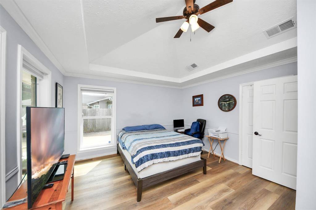 Another view of this versatile bedroom highlights the many possibilities for use—whether as a guest retreat, home office, or study—and includes its own private door to the outside.
