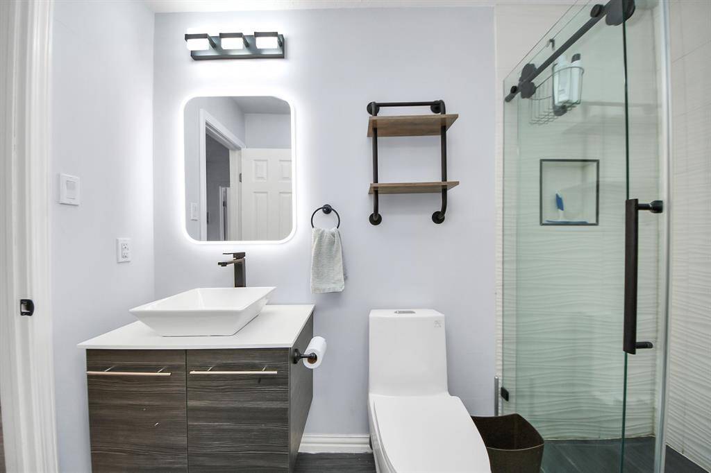 A tech-savvy mirror adds a modern touch and serves as a unique conversation piece in this bathroom.