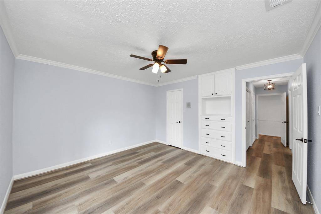 The third bedroom offers built-in cabinets and drawers for added functionality, along with an exceptionally large walk-in closet—perfect for generous storage or organization.