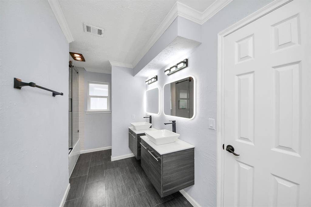 You can never go wrong with a third full bathroom! This one features dual sinks, a tub/shower combo, and stylish touch mirrors that add both function and flair.