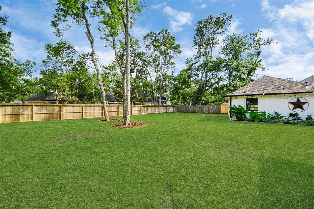 A recently installed fence encloses the huge backyard with endless possibilities—whether for play, gardening, entertaining, or even adding a pool.