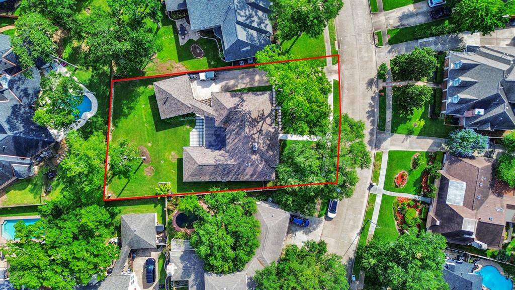 An aerial view reveals the full scope of this beautiful home and its expansive lot, showcasing the spacious layout and generous outdoor living areas.