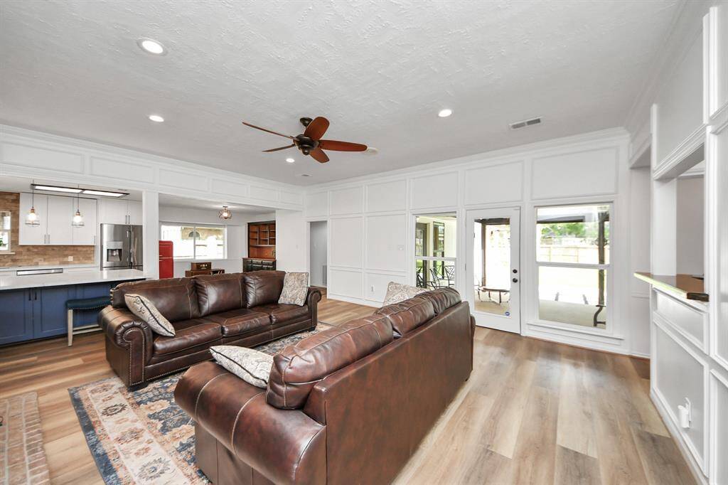 The den opens directly to the kitchen, fostering family interaction and creating the perfect setting for gatherings and holiday celebrations.