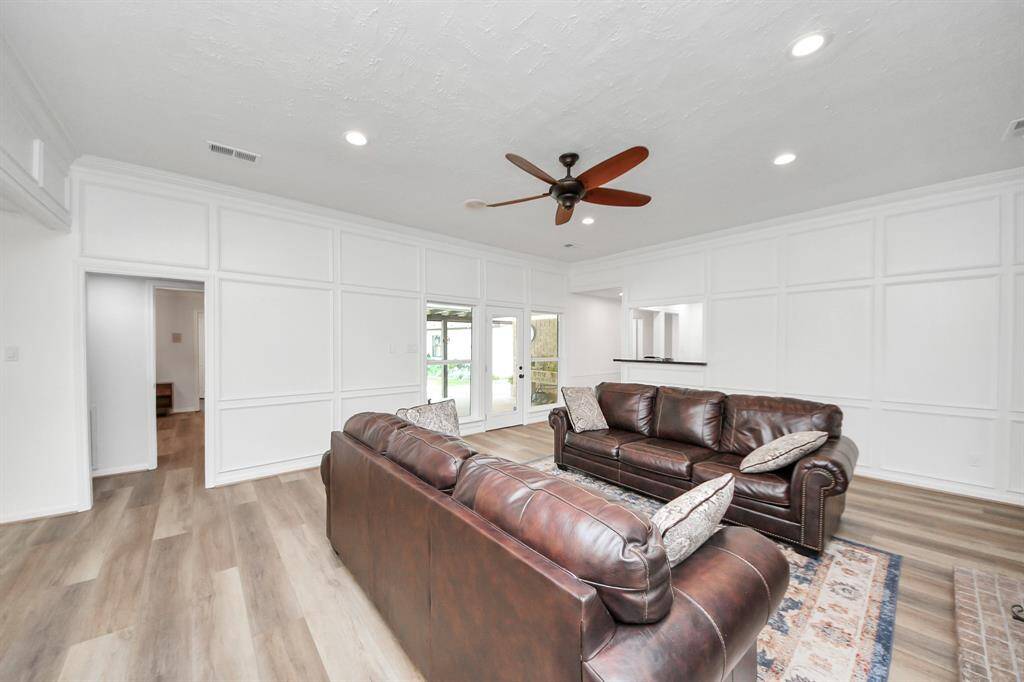 Elegant French doors off the den open to the lush backyard and spacious covered patio—blending indoor comfort with outdoor living.