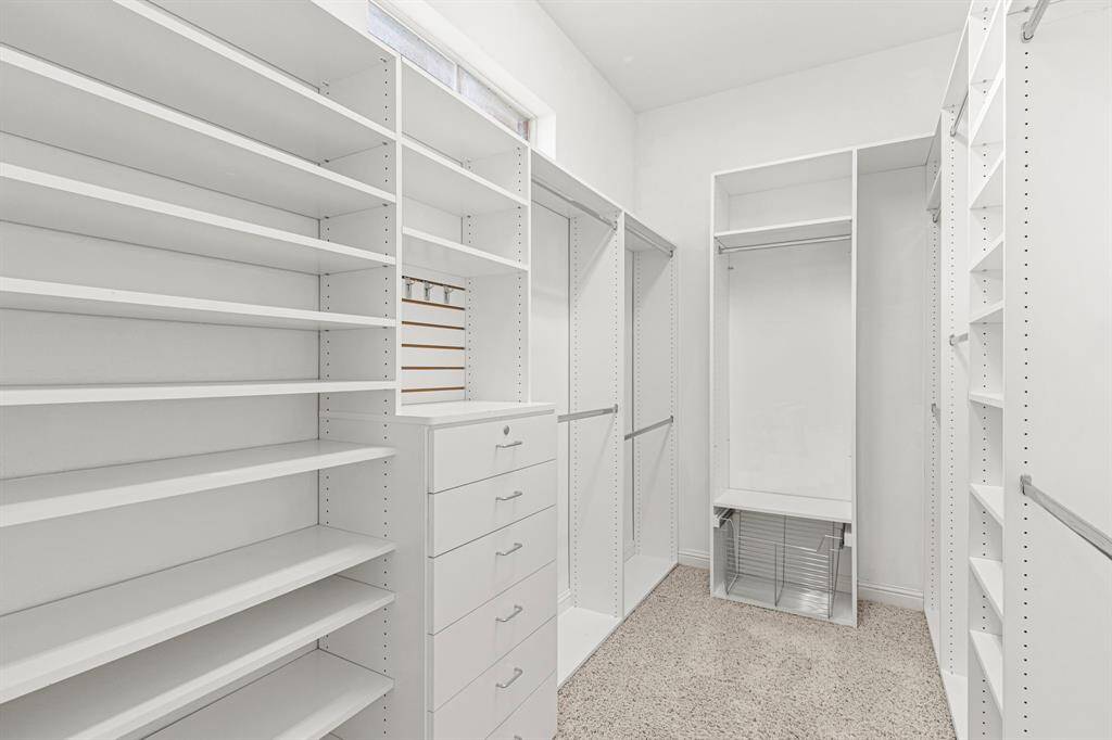 California Closet system allows lots of space for shoes!  This closet will keep you organized. A mirror above the shelves bring in natural light.