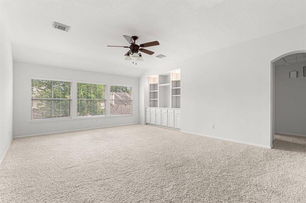 The large gameroom has room for a pool table. The built-in provides a place for games and your entertainment system.