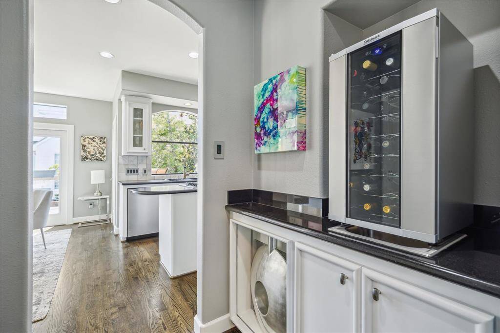 Wet bar with a sink and cabinet storage is located between the dining area and kitchen.