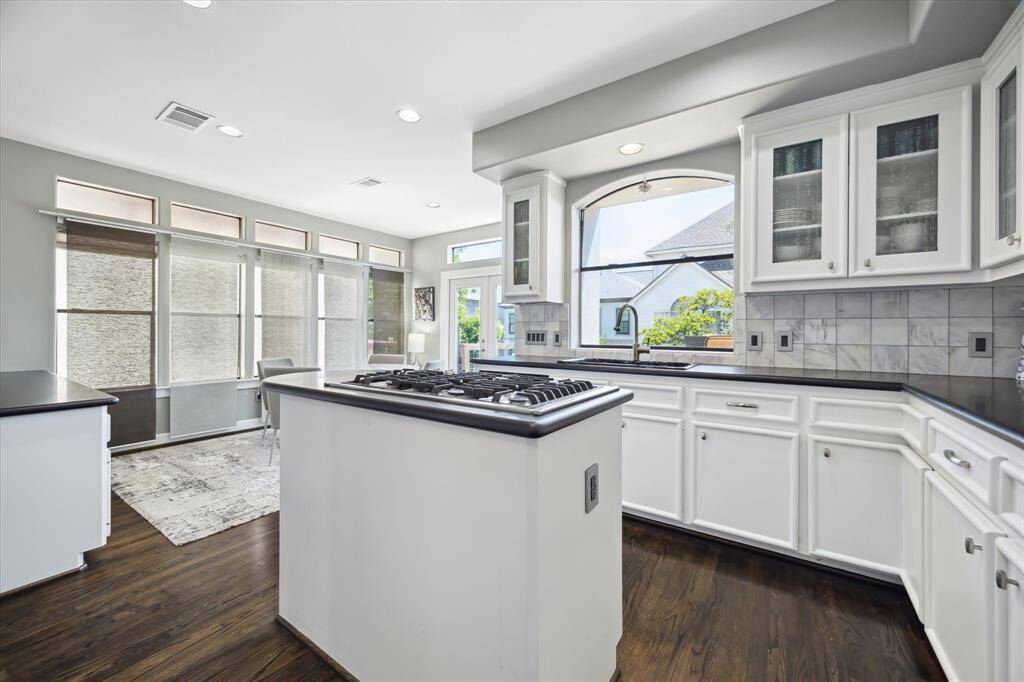 What a fabulous island kitchen, high ceilings, stainless steel appliances, granite counters, and the beautiful dark wood floors.
