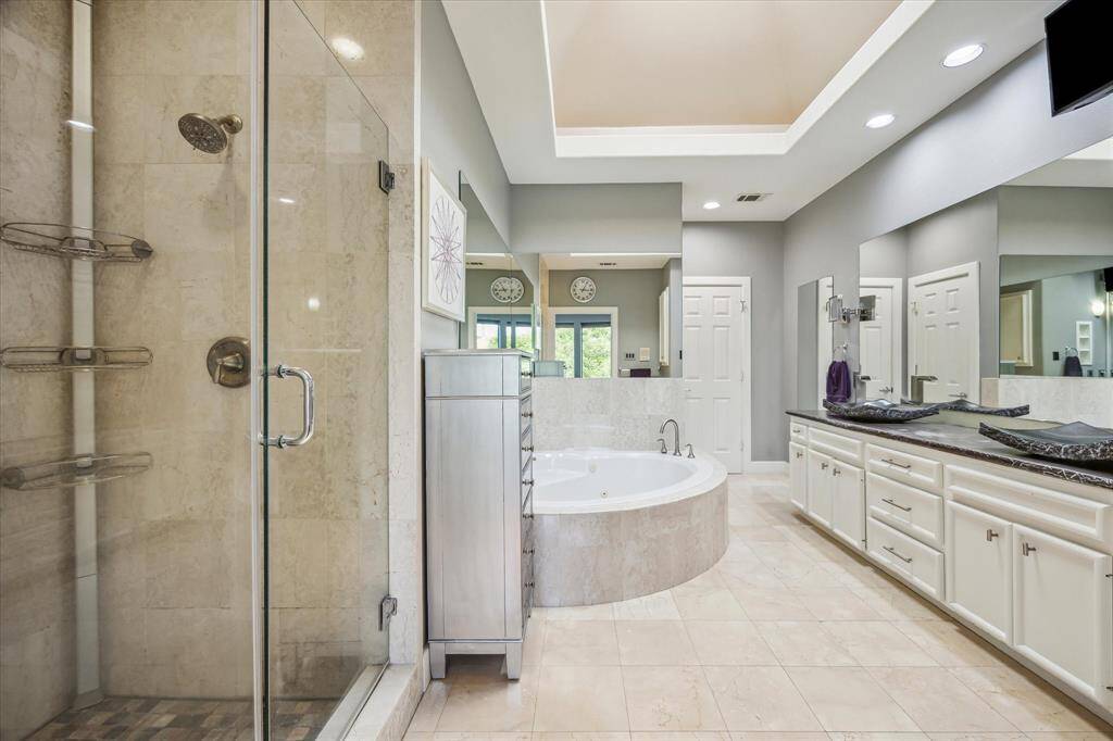 The primary bath, a soothing and relaxing place. Dual vanity area with vessel sinks jetted tub, separate enclosed shower and large walk-in closet complete the primary suite.