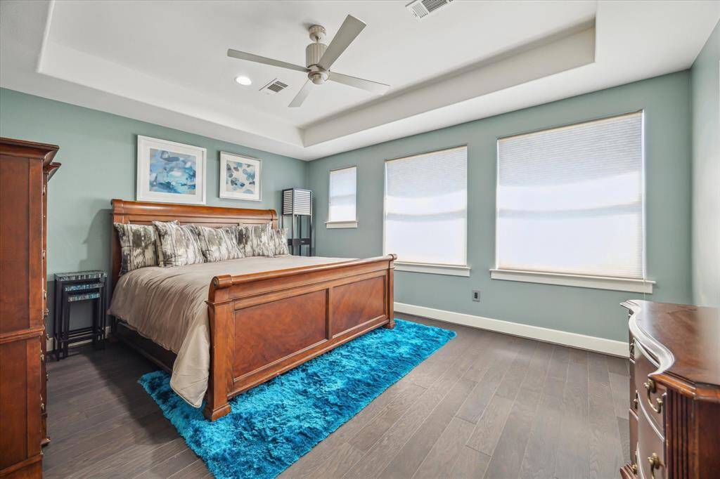 Third floor guest bedroom, a good-sized room, trey ceiling, engineered wood flooring and windows allow for natural light.