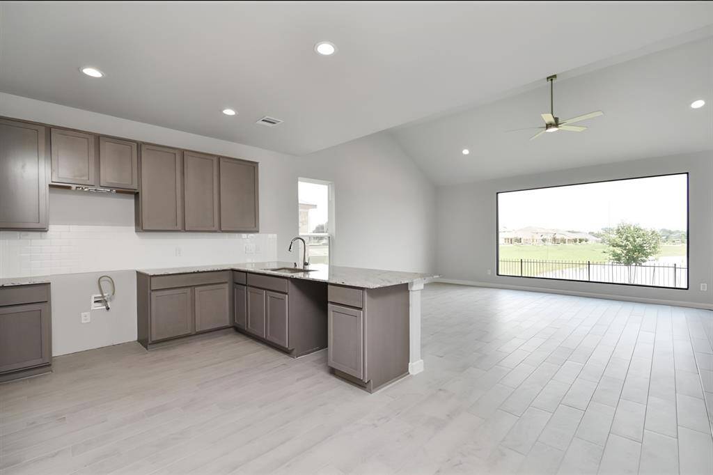 All of this overlooks your expansive family room, creating a perfect space for culinary delights and family gatherings. Sample photo of completed home with similar floor plan. As-built interior colors and selections may vary.