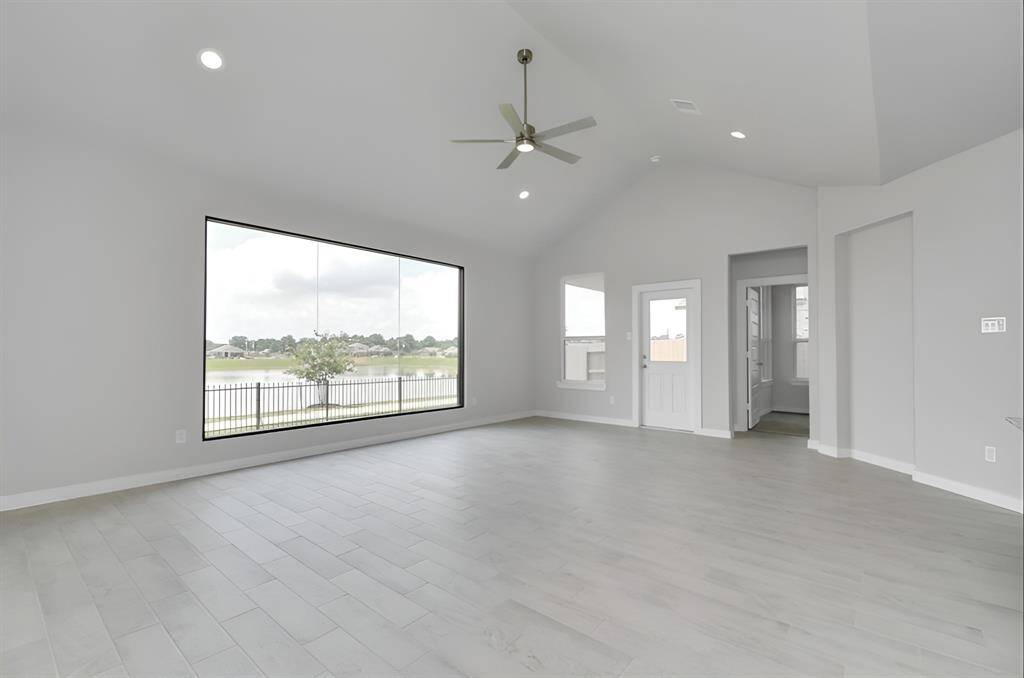 Take another glimpse into the heart of the home with this additional view of the family room—a sprawling space ready to accommodate all your gatherings. Sample photo of completed home with similar floor plan. As-built interior colors and selections may vary.