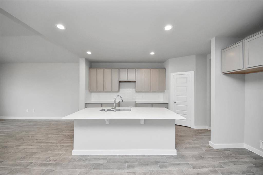 The kitchen is a culinary haven, featuring granite countertops, a tile backsplash, stainlesssteel appliances, and 42” upper cabinets.