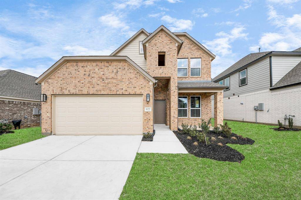 Behold a lush landscape, impeccably maintained yard, and apremium elevation adorned with captivating brick and stone features.