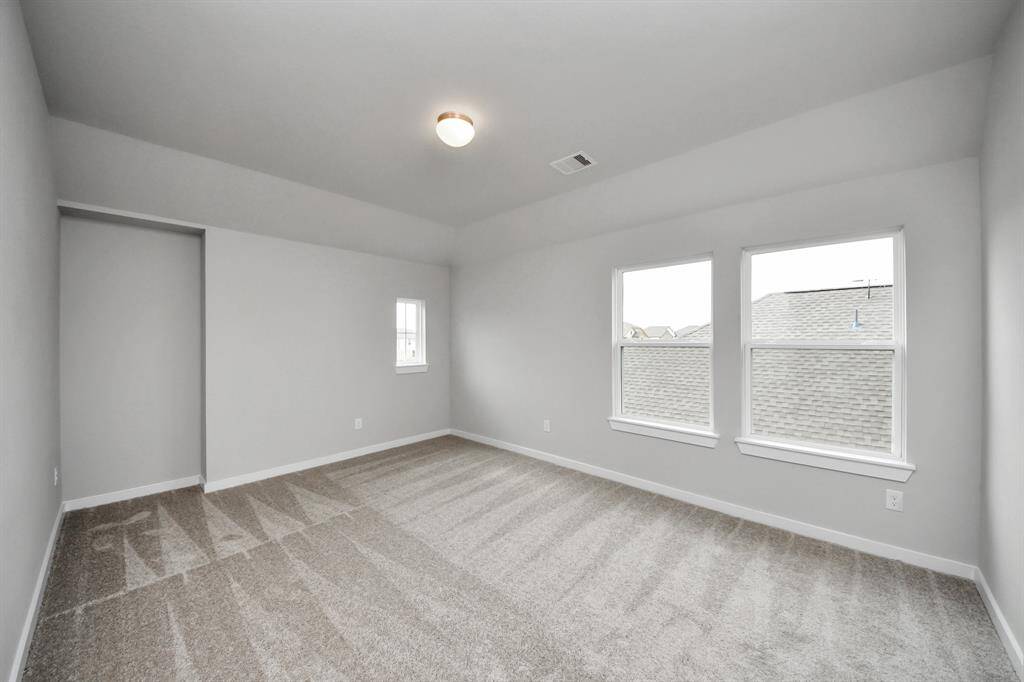 Come upstairs and relish a day of relaxation in this loft area! Ideal as anadditional living space or game room, it boasts plush carpeting, high ceilings,custom paint, and windows that flood the area with abundant natural light.