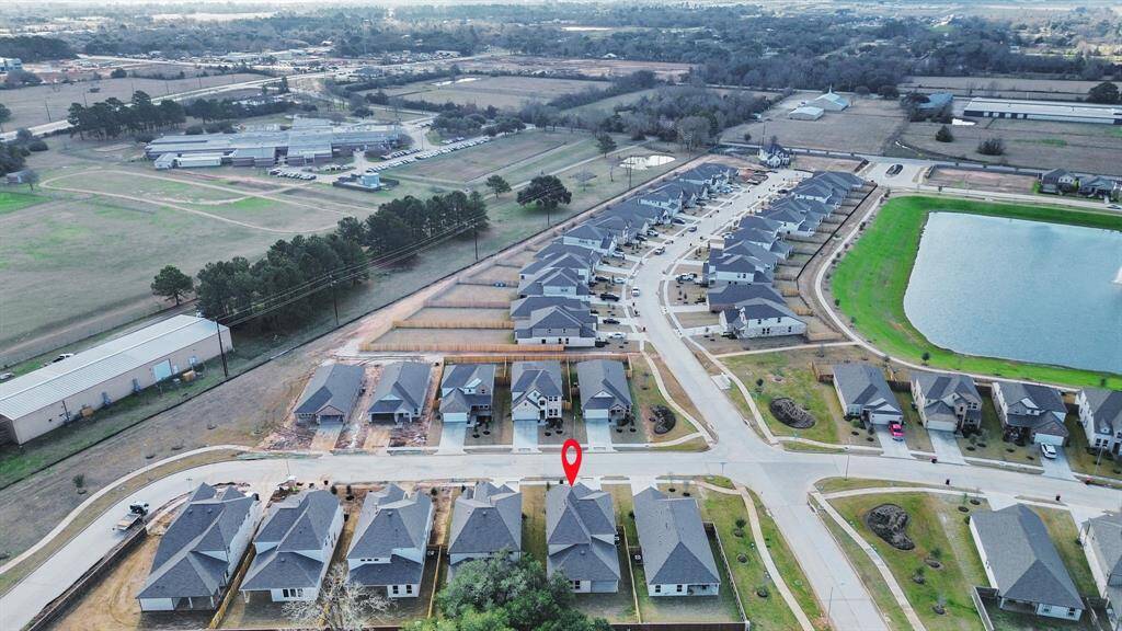An aerial view of a spacious subdivision lot, highlighting a well-maintained yard and a fully fenced perimeter, offering both privacy andexpansive outdoor space.
