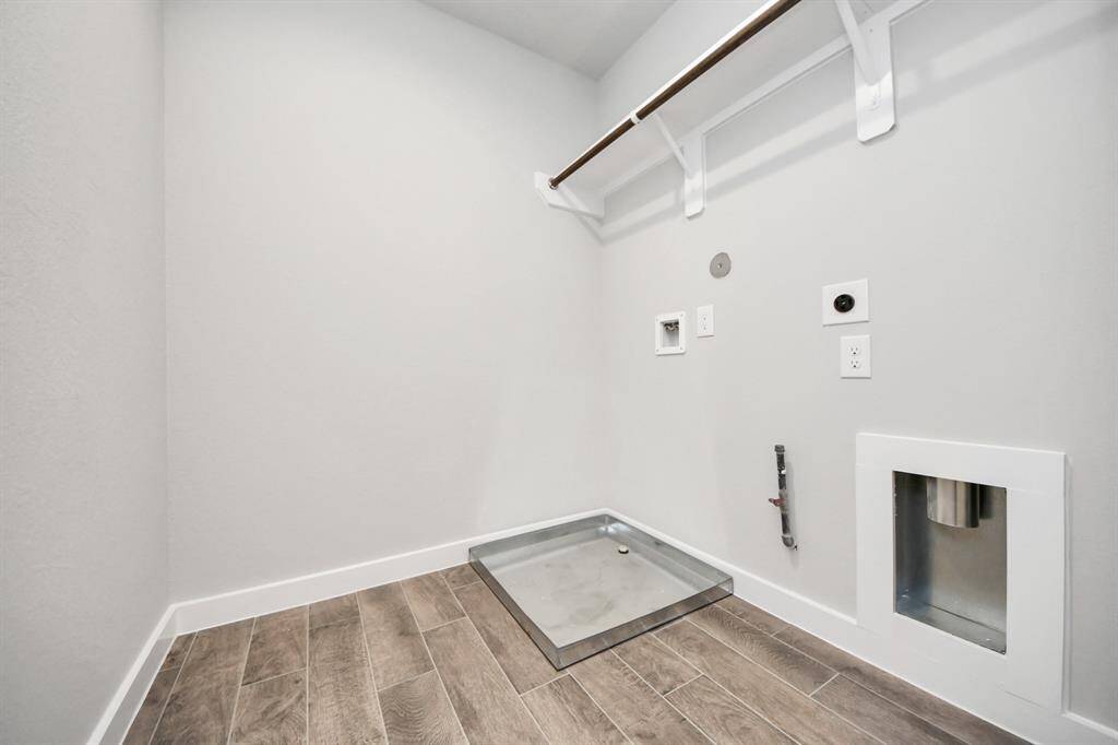 A perfect blend of functionality and comfort. Capture the essence of easy living with a first-floor laundry room, thoughtfully equipped with shelving for effortless organization. Bothelectric and gas connections available.