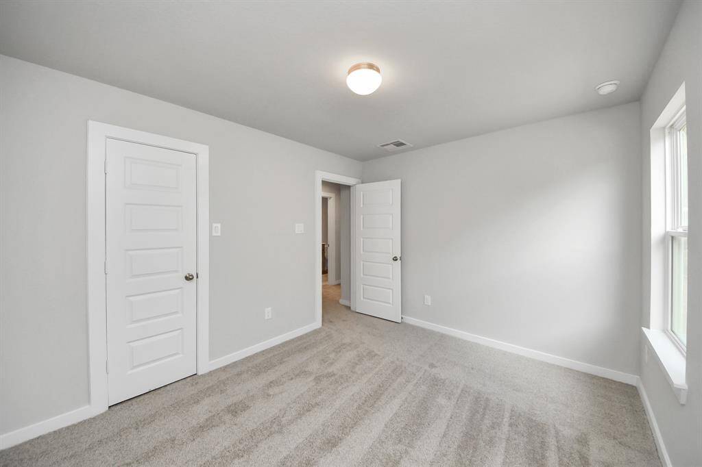 Generously sized secondary bedrooms featuring spacious closets, soft and inviting carpetingunderfoot, large windows allowing plenty of natural light, and the added touch of privacyblinds for your personal retreat.